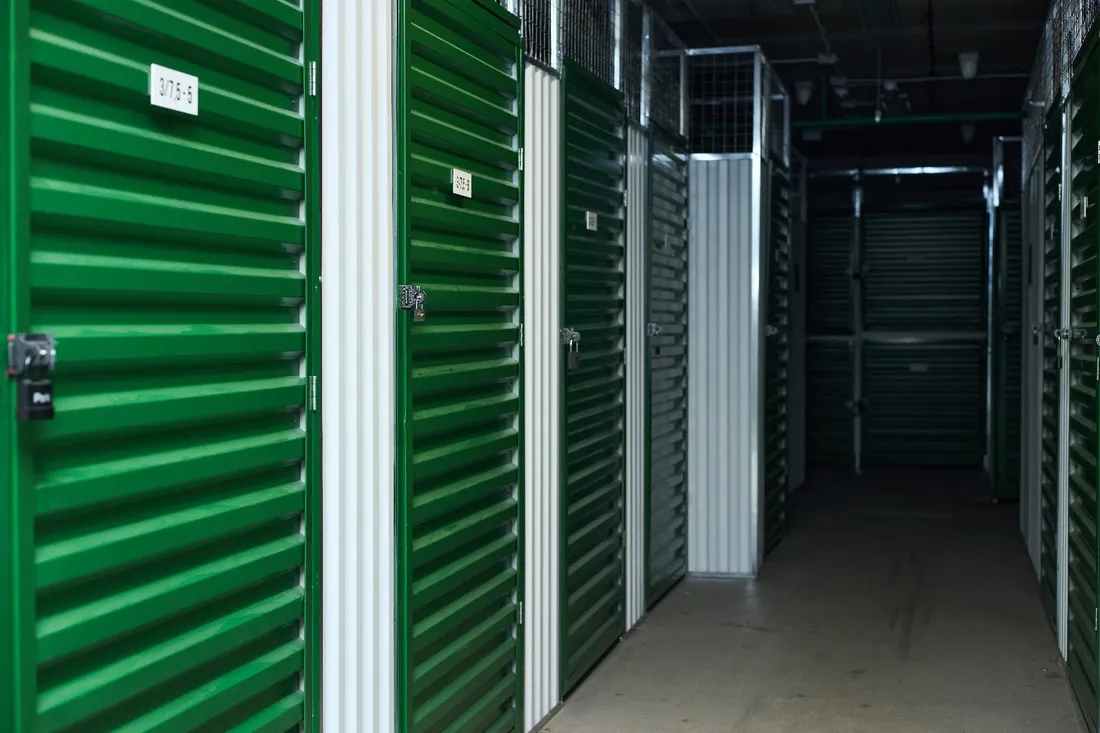 A lit interior corridor of climate controlled storage units